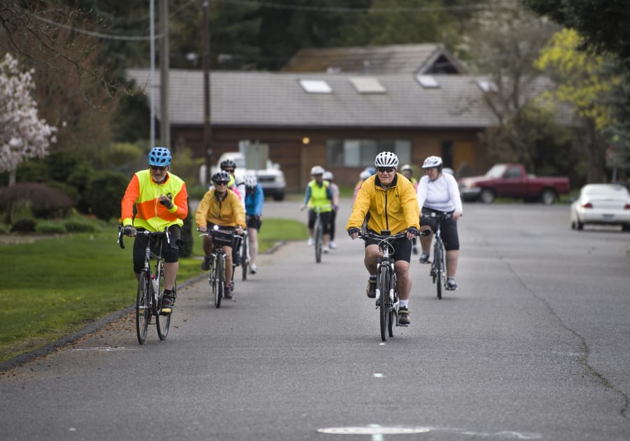 Steve Trinkle, left, and Tony Licata, right, lead a group of cyclists on a ride near McLoughlin Middle School. The Vancouver Bicycle Club is hosting Monday evening rides geared to people who want to get comfortable with road cycling but need guidance getting up to speed.