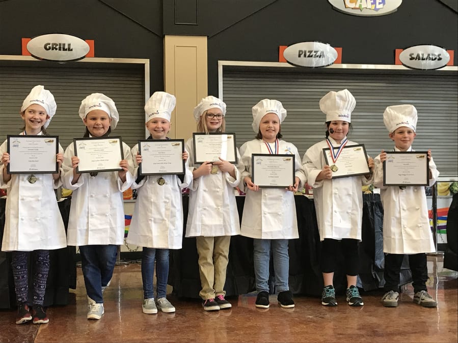 Washougal: Washougal elementary school students, from left, Hannah Carlin, Charlotte Bisila, Lily Mayer, Mari Jayne Kephart, McKenzie Olkowski, Makayla Cain and Silas Hall, competed in the Sodexo Future Chefs Challenge, where they were asked to prepare healthy Asian fusion dishes.