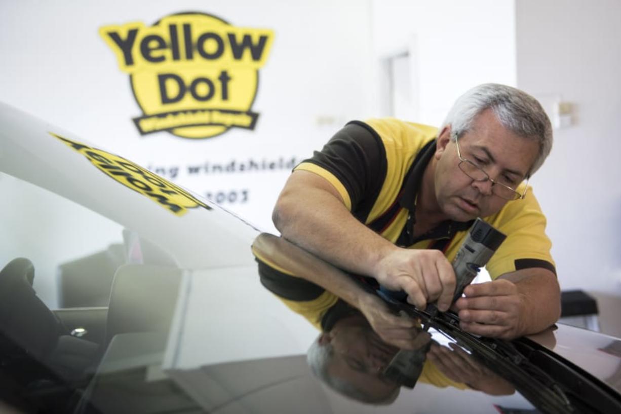 Steve Harmon, owner of Yellow Dot Windshield Repair, prepares a chip for repair at his shop in Vancouver on Wednesday afternoon. Harmon started his business in 2003 and spent many years at Vancouver Mall. He recently relocated to his own shop on East 18th Street.