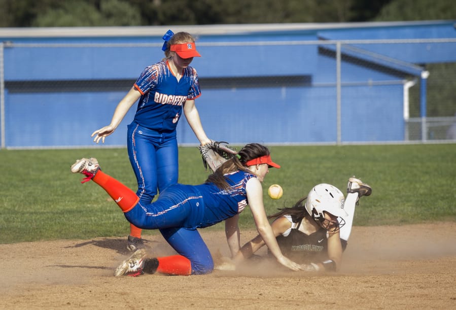 Woodland’s Payten Foster (10) slides into second during a game against Ridgefield at Ridgefield High School, Thursday April 26, 2018.