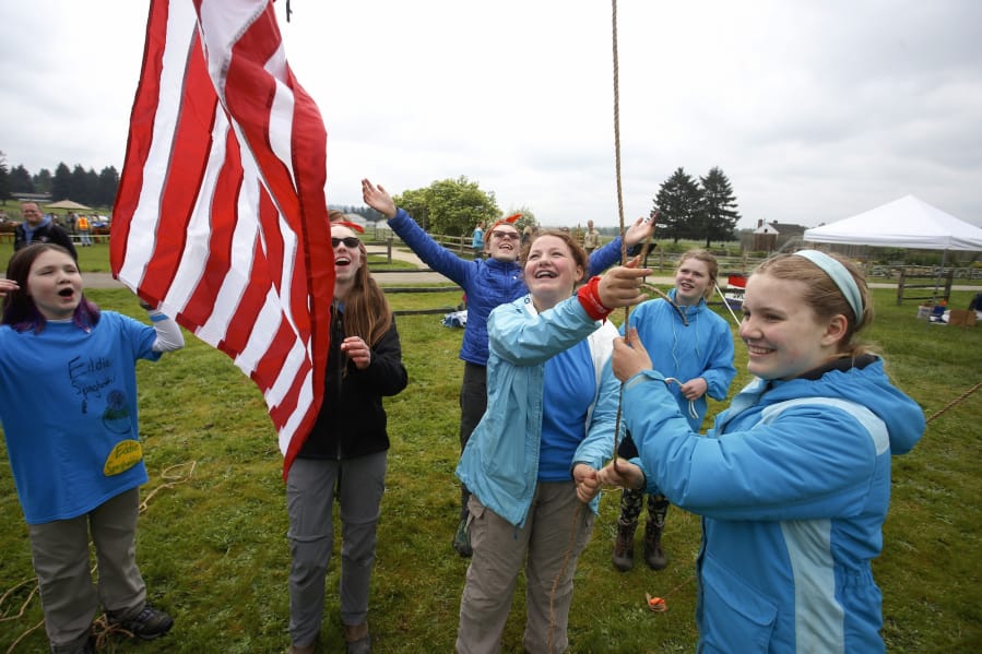 From left, Allison Mckellar, 11, Ellie Stewart, 14, Helen Dreasher, 12, Viridian Klei, 13, Freya Rozell, 13 and Anneke Talke, 13, raise a flag at the Boy Scouts’ 2018 Camporee on Saturday. Their unit, called Eddie Spaghetti Patrol, was one of two all-girls units at the weekend event.