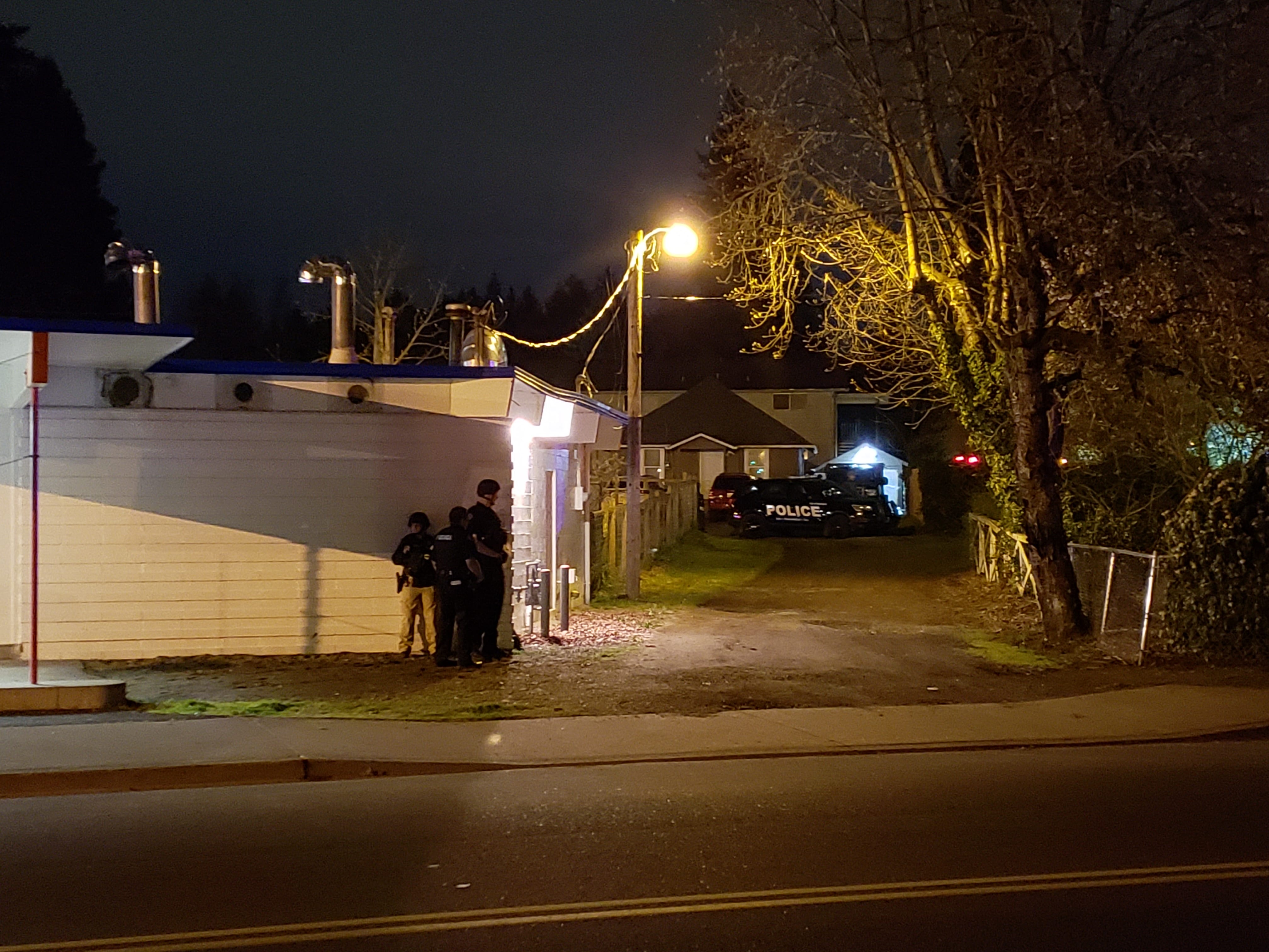 Vancouver police search the Rose Village neighborhood Wednesday night for a man wanted for multiple alleged incidents, including the discharge of a firearm and ramming a police vehicle.