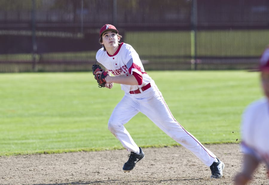 Fort Vancouver junior shortstop Nick Laurenza runs to catch a fly ball during the game against Prairie High School at Fort Vancouver High School, Thursday April 19, 2018.