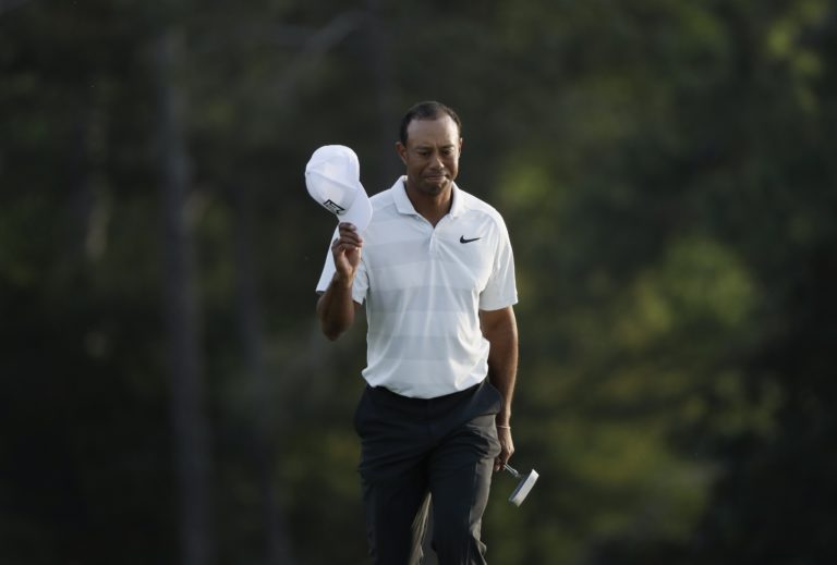 Tiger Woods tips his hat on the 18th green during the second round at the Masters golf tournament Friday, April 6, 2018, in Augusta, Ga. (AP Photo/David J.