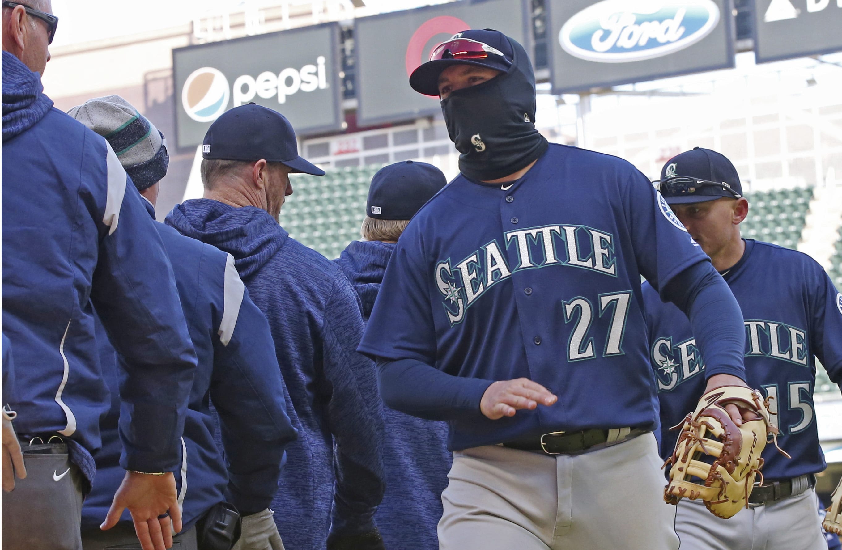 Seattle Mariners' Ryon Healy goes through the celebration line after the Mariners defeated the Minnesota Twins 11-4 in a baseball game Saturday, April 7, 2018, in Minneapolis.