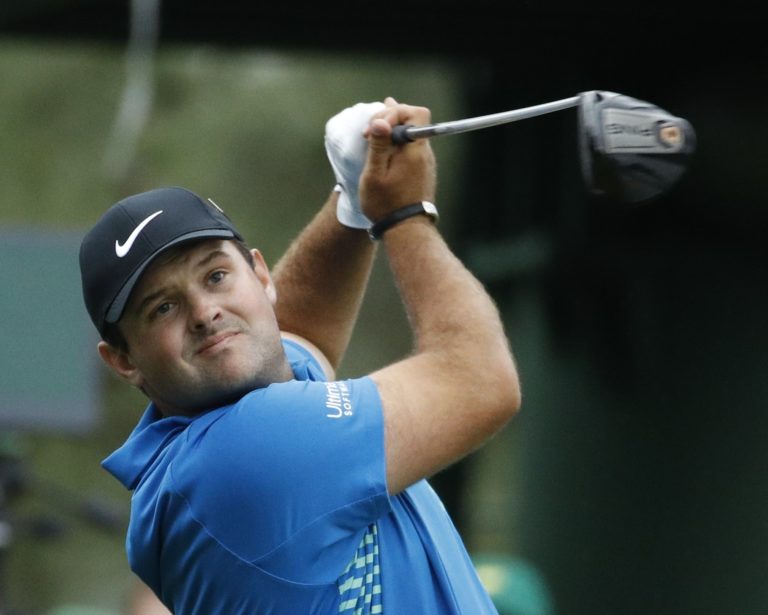 Patrick Reed hits a drive on the 18th hole during the third round at the Masters golf tournament Saturday, April 7, 2018, in Augusta, Ga.