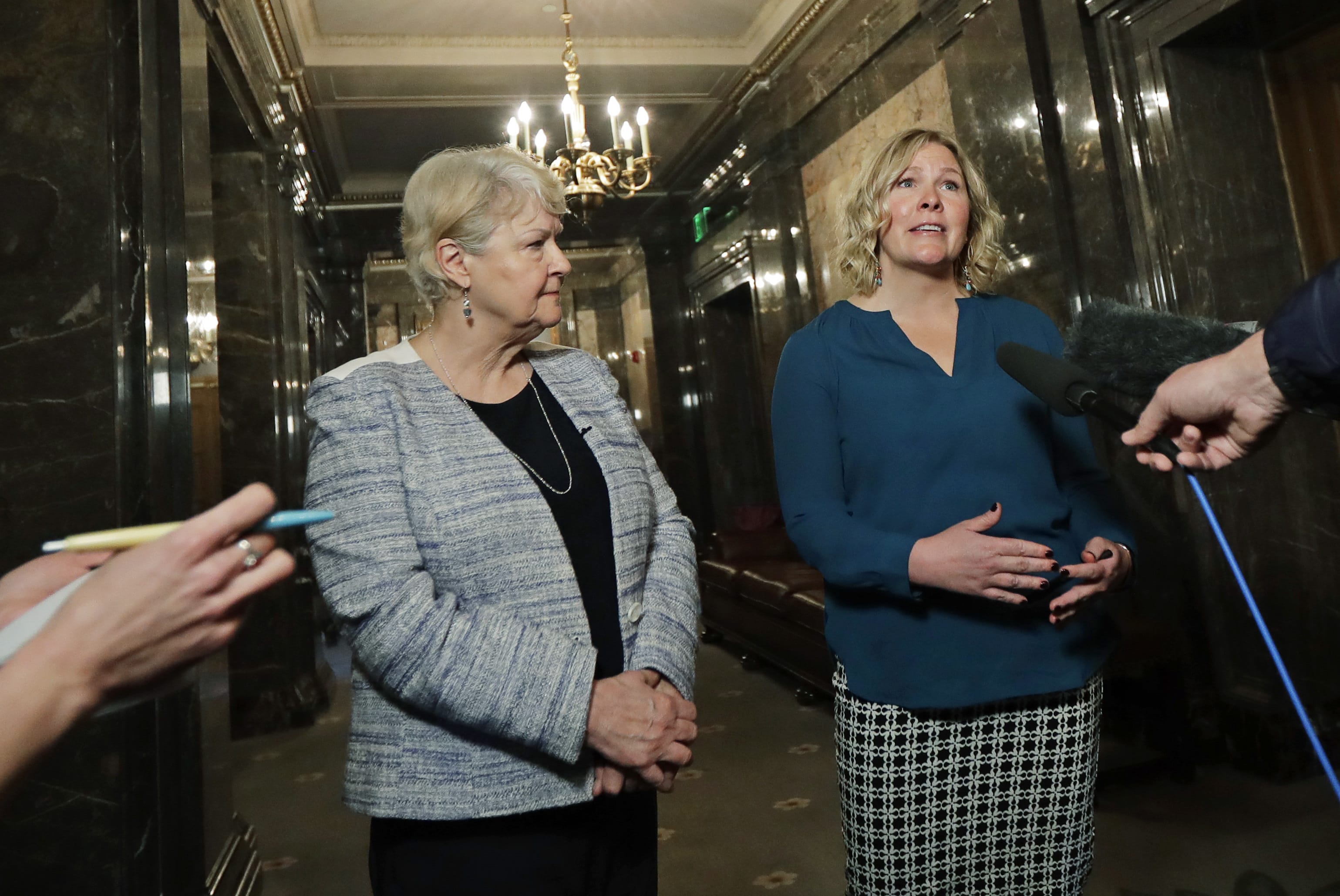In this March 21, 2018, photo, Rebecca Johnson, right, a lobbyist who helped organize a letter signed by more than 200 women calling for a culture change at the Washington state Capitol, talks to reporters as Sen. Karen Keiser, D-Des Moines, left, looks on in Olympia, Wash. Washington's legislative session is over but the conversation about sexual harassment at the state Capitol continues, with the House and Senate each convening their own groups to discuss potentials codes of conduct and how to address complaints. (AP Photo/Ted S.