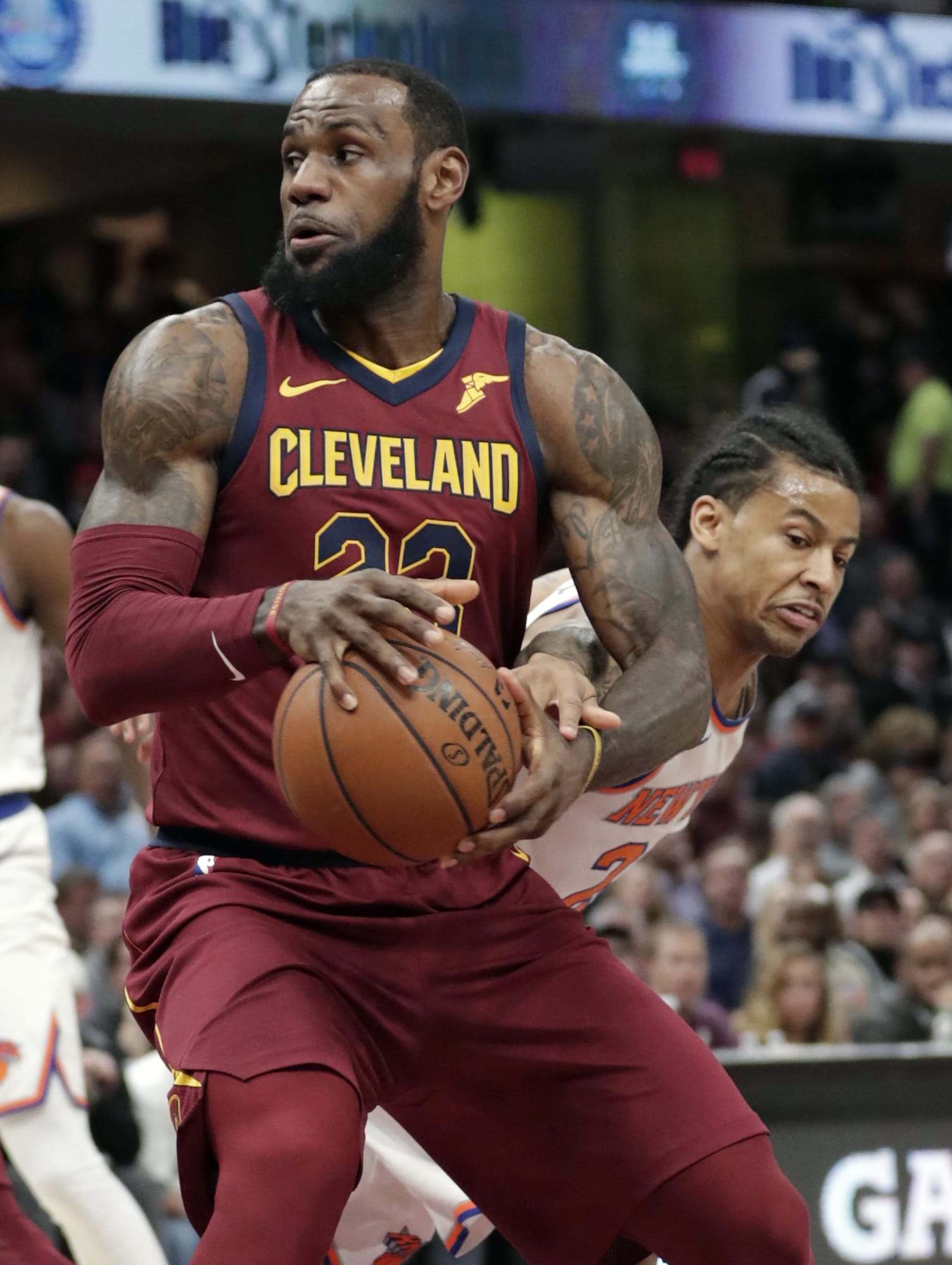 Cleveland Cavaliers' LeBron James, left, drives past New York Knicks' Trey Burke in the first half of an NBA basketball game, Wednesday, April 11, 2018, in Cleveland.