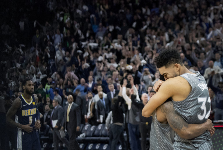 Minnesota Timberwolves' Karl-Anthony Towns, right, and Jeff Teague celebrate after the team's win over the Denver Nuggets in an NBA basketball game Wednesday, April 11, 2018, in Minneapolis.
