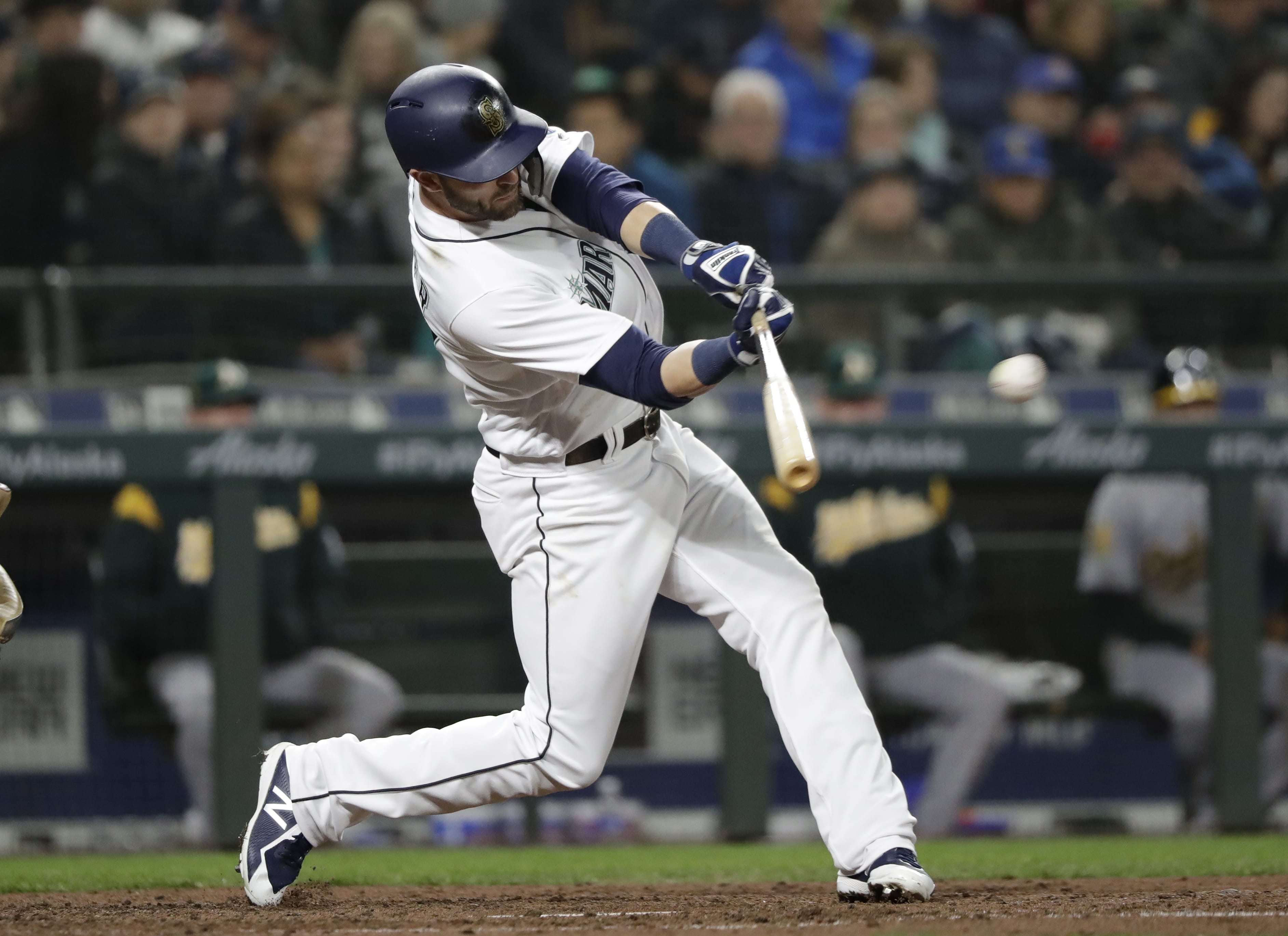 Seattle Mariners' Mitch Haniger connects on a 2-RBI single against the Oakland Athletics in the third inning during a baseball game Saturday, April 14, 2018, in Seattle.