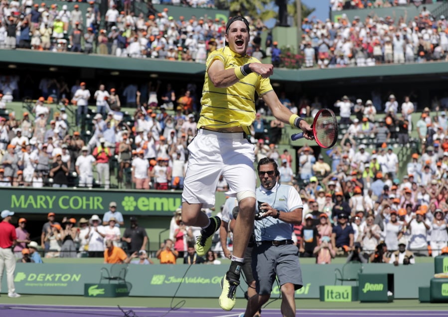 John Isner celebrates after defeating Alexander Zverev, of Russia, during the final at the Miami Open tennis tournament Sunday, April 1, 2018, in Key Biscayne, Fla. John Isner won the biggest title of his 14-year career on Sunday, holding every service game and rallying past Zverev in the Miami Open final, 6-7 (4), 6-4, 6-4.