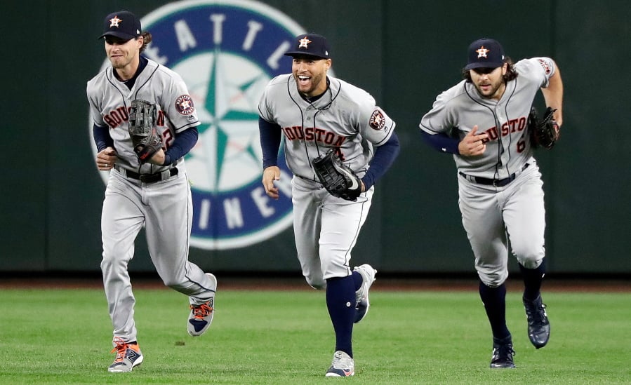 Houston Astros outfielders Josh Reddick, left, George Springer and Jake Marisnick celebrate victories this season by doing dances inspired by the Fortnite Battle Royale video game.