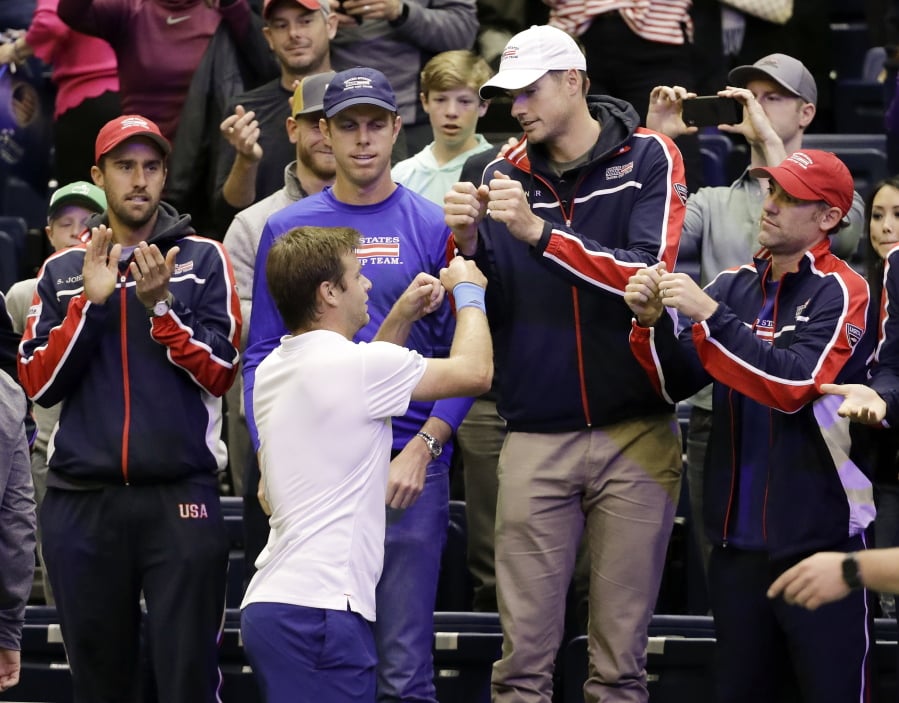 Ryan Harrison, of the United States, celebrates with teammates after beating Ruben Bemelmans, of Belgium, in a Davis Cup quarterfinal singles tennis match Sunday, April 8, 2018, in Nashville, Tenn. The United States clinched the series Saturday to move on to the semifinals.
