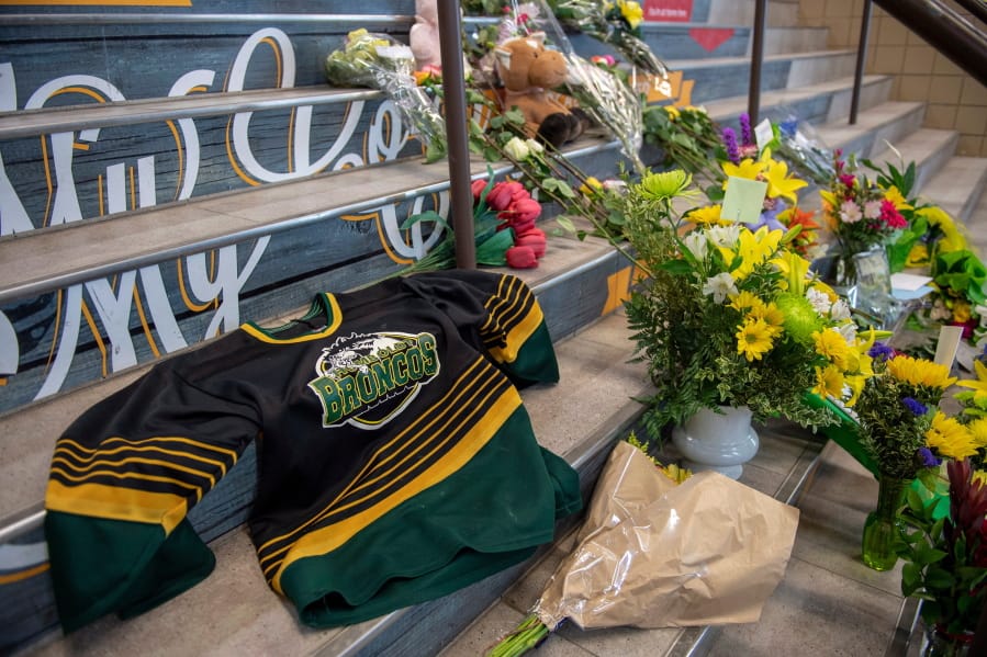 A memorial at the stairs that lead to Elgar Petersen Arena is shown in Humboldt, Saskatchewan, on Saturday, April 7, 2018. Royal Canadian Mounted Police say 14 people are dead and others injured Friday after a truck collided with a bus carrying a junior hockey team to a playoff game in northeastern Saskatchewan. Police say there were 28 people including the driver on board the Humboldt Broncos bus when the crash occurred at around 5 p.m. on Highway 35 north of Tisdale.