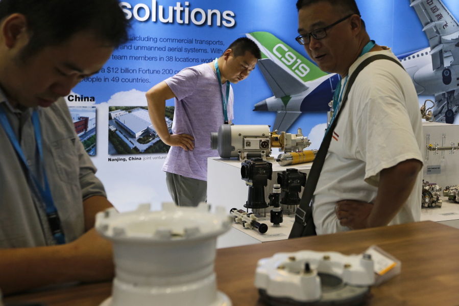 Visitors look at airplane component parts on display at Aviation Expo China in Beijing. China On Wednesday vowed to take measures of the “same strength” in response to a proposed U.S. tariff hike on $50 billion worth of Chinese goods in a spiraling dispute over technology policy that has fueled fears it might set back a global economic recovery. The Commerce Ministry said it would immediately challenge the U.S. move in the World Trade Organization.