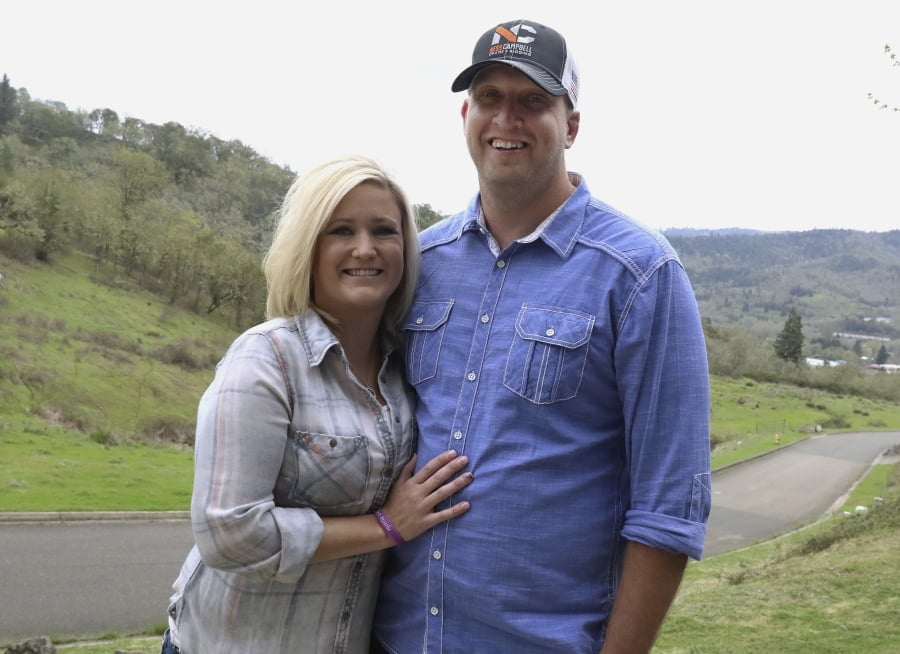 In this April 14, 2018, photo, Jennifer Myers and Brian Boswell pose for a photo at their Roseburg, Ore., home. Myers was born with cystic fibrosis and successfully underwent lung transplant surgery in 2015.