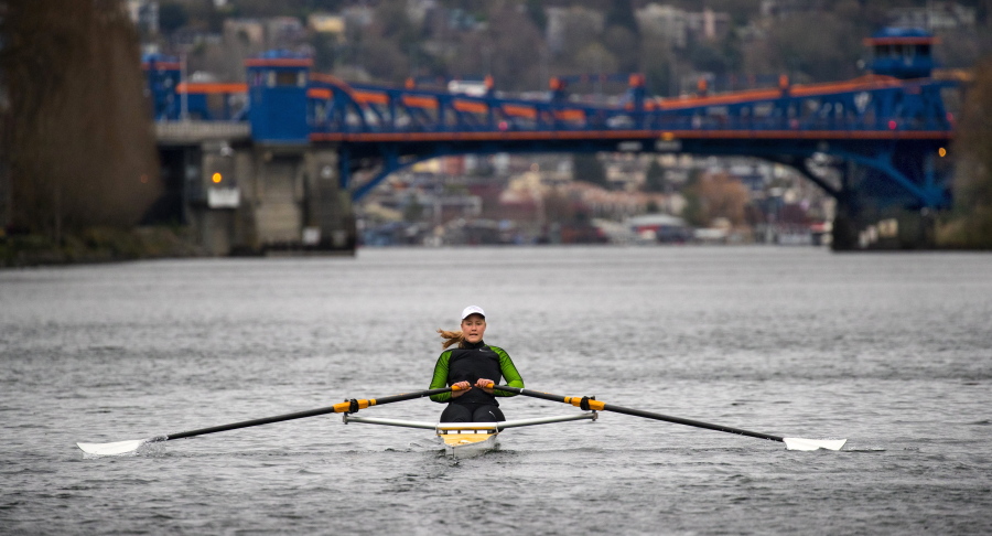 In a Thursday, March, 29, 2018 photo, Eliza Dawson trains at the Seattle Rowing Center and spends hours each day rowing in waters including this part of the Fremont Cut toward the Fremont Bridge, in Seattle, Wash. a former UW crew member, is part of a four-woman team that will row across the Pacific to Hawaii this June. She and her team want to try to break the record for women rowers.