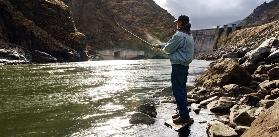 Fisherman Larry McBrom works along the Snake River shoreline below Hells Canyon Dam on Nov. 16, 2003, in southwestern Idaho. Idaho officials have approved an agreement allowing a utility company’s $216.5 million in relicensing expenses for a three-dam hydroelectric project on the Snake River on the Idaho-Oregon border.