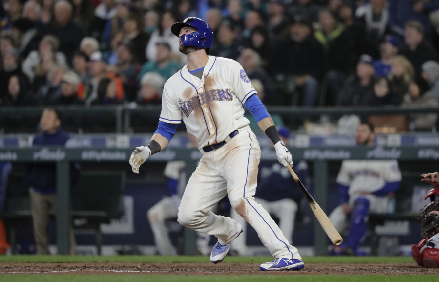 Seattle Mariners’ Mitch Haniger watches his two-run home run against the Cleveland Indians during the seventh inning of a baseball game Sunday, April 1, 2018, in Seattle. (AP Photo/Ted S.