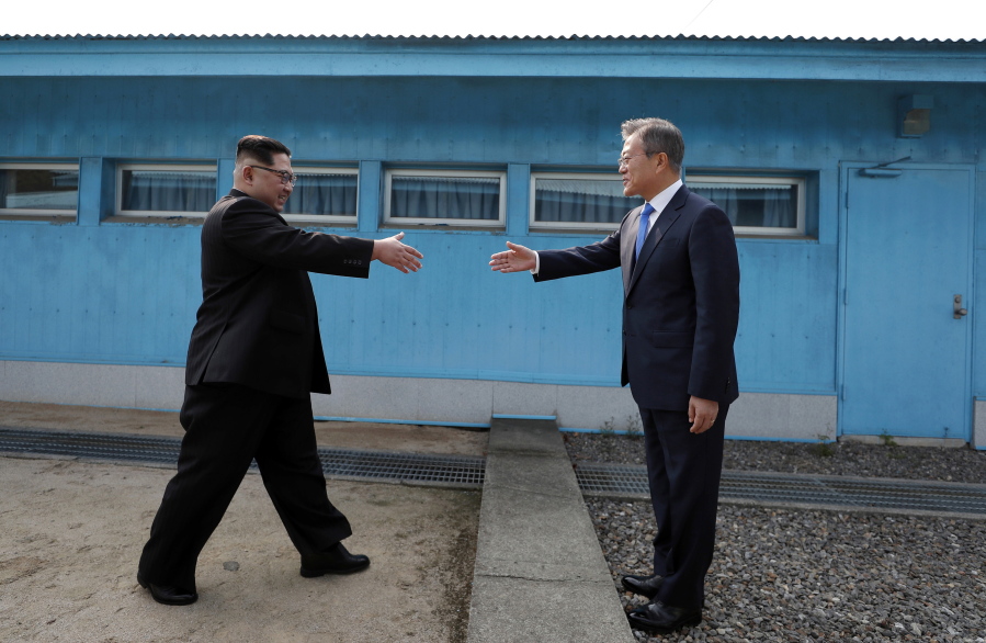 North Korean leader Kim Jong Un, left, prepares to shake hands with South Korean President Moon Jae-in at the border village of Panmunjom in Demilitarized Zone Friday, April 27, 2018. Their discussions will be expected to focus on whether the North can be persuaded to give up its nuclear bombs.