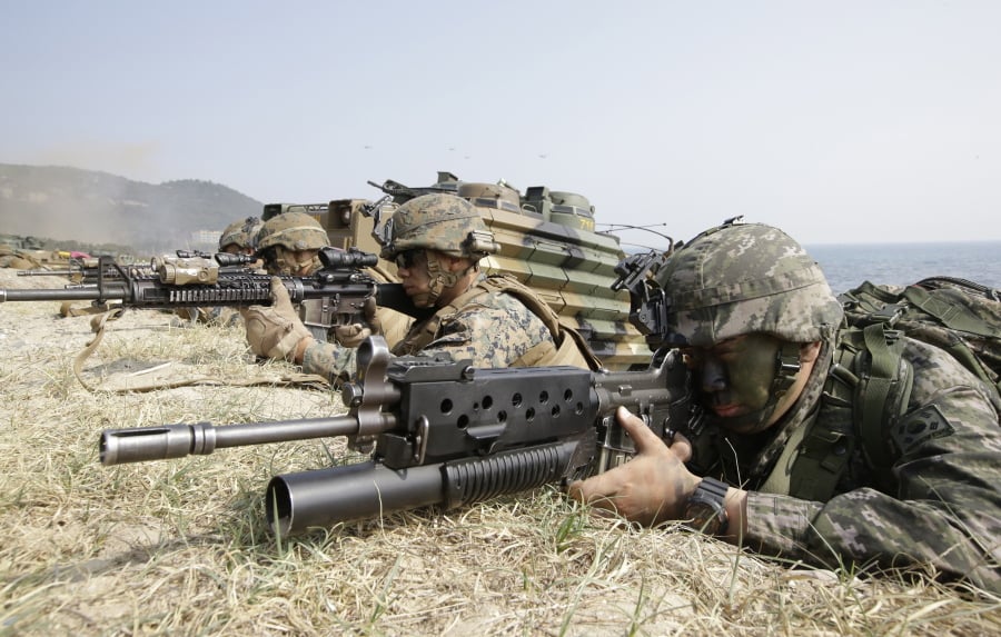 South Korean Marine, right and U.S. Marines aim their weapon near amphibious assault vehicles during the U.S.-South Korea joint landing military exercises as a part of the annual joint military exercise Foal Eagle between South Korea and the United States in Pohang, South Korea. The United States and South Korea have toned down their annual war games as North Korean leader Kim Jong Un prepares for summits with South Korea and President Donald Trump.