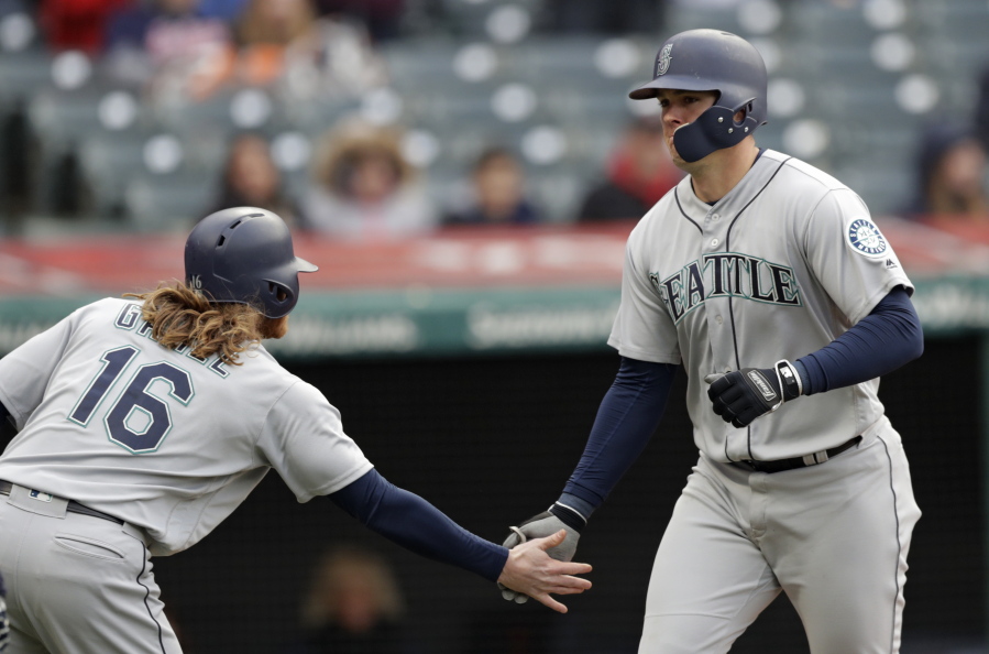 Seattle Mariners’ Ryon Healy, right, is congratulated by Ben Gamel after Healy hit a two-run home run off Cleveland Indians relief pitcher Dan Otero during the ninth inning of a baseball game, Saturday, April 28, 2018, in Cleveland. Gamel scored on the homer. The Mariners won 12-4.