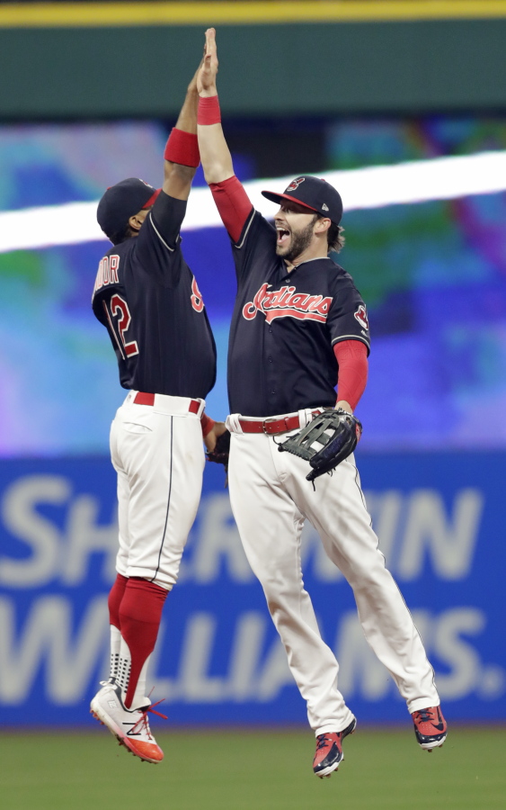 Cleveland Indians’ Francisco Lindor, left, and Tyler Naquin celebrate after the Indians defeated the Seattle Mariners 6-5 in a baseball game Friday, April 27, 2018, in Cleveland.