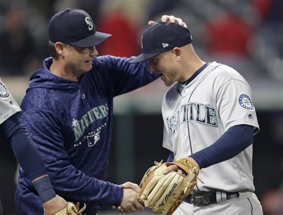 Seattle Mariners manager Scott Servais, left, congratulates Kyle Seager after the Mariners defeated the Cleveland Indians 5-4 Thursday in Cleveland.