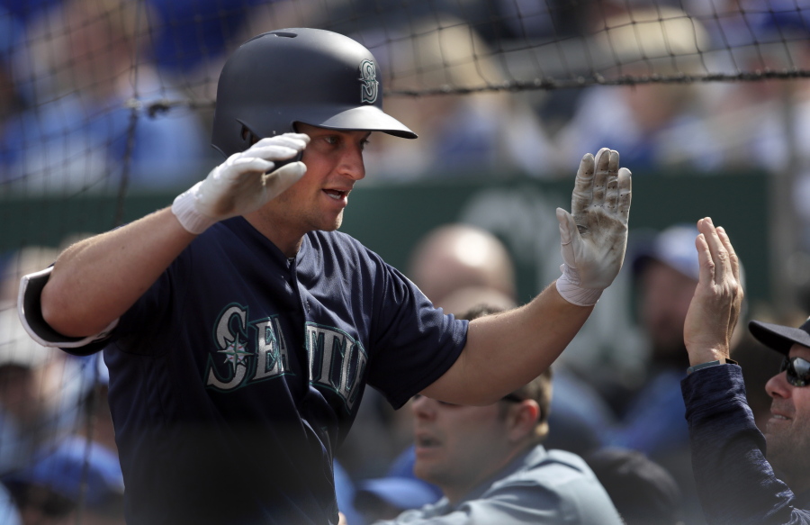 Seattle Mariners' Kyle Seager is greeted by teammates following his two-run home run during the eighth inning of a baseball game against the Kansas City Royals at Kauffman Stadium in Kansas City, Mo., Wednesday, April 11, 2018.