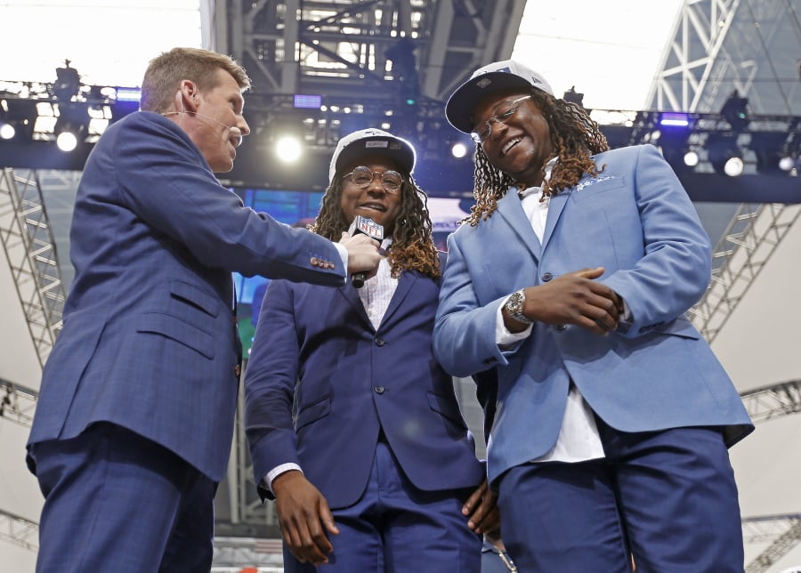 NFL Network’s Scott Hanson, left, talks with Seattle Seahawks cornerback Shaquill Griffin, center, and Shaquem Griffin on stage during the NFL football draft in Arlington, Texas, Saturday, April 28, 2018. The Seahawks selected Shaquem in the fourth round. (Jae S.