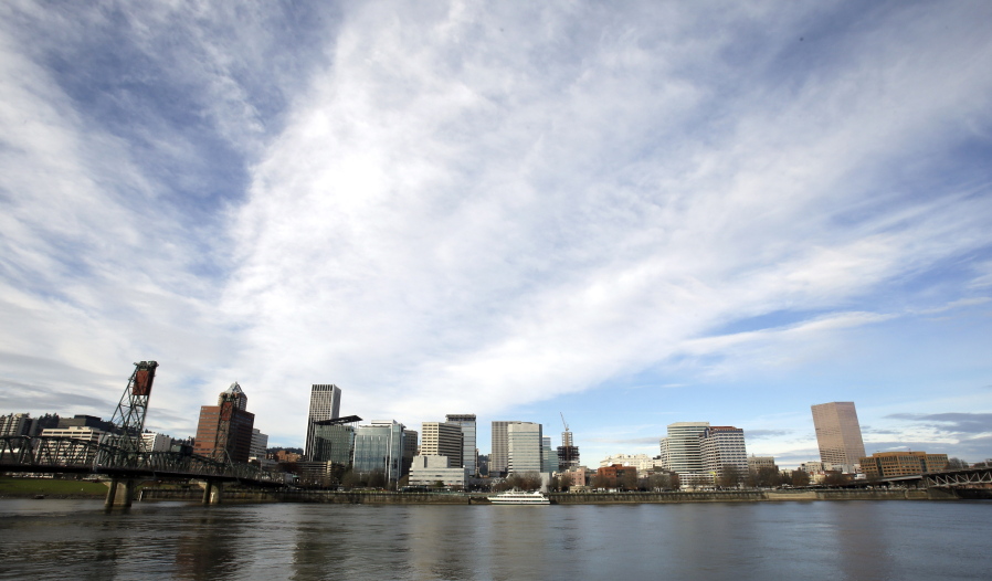 The Portland skyline is visible Dec. 13, 2014, on the west bank of the Willamette River in Portland. A new report lists four Oregon metro areas among the nation’s worst 50 for air pollution spikes.