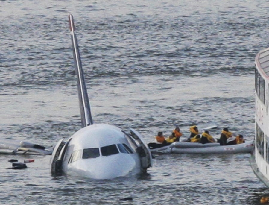 Passengers in an inflatable raft move away from US Airways Flight 1549 on Jan. 15, 2009. The plane ditched in the Hudson River after both engines failed when they ingested birds shortly after takeoff. All 155 people on board were safe; Captain Chesley Sullenberger and other crew members were hailed as heroes.