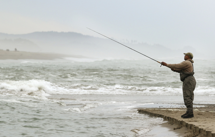 Phil Pope casts out into Siletz Bay as the high tide comes in Sept. 14, 2015, while fishing for salmon in Lincoln City, Ore. One year after a crash in Klamath River salmon returns sparked a full-scale closure, sport anglers off the Southern Oregon coast are on track for a 100-day chinook season from mid-May through late August.