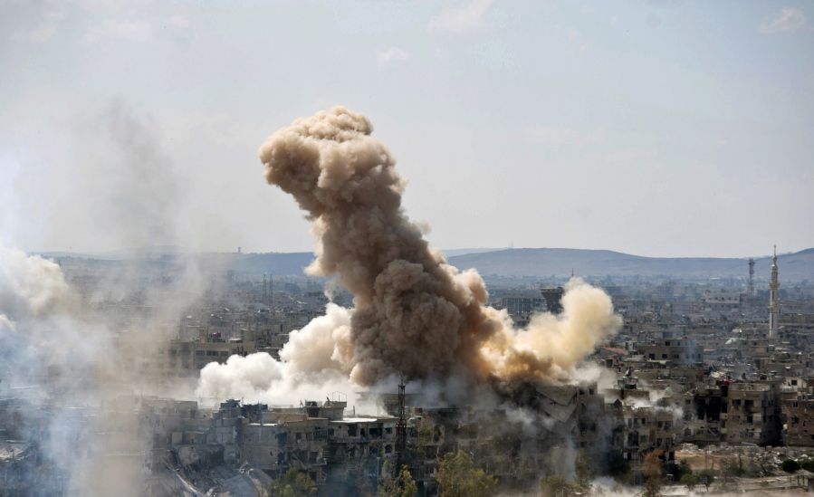 Smoke rises Sunday after Syrian government airstrikes and shelling hit in Hajar al-Aswad neighborhood held by Islamic State militants, southern Damascus, Syria.