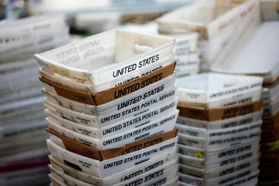 FILE- In this Dec. 14, 2017, file photo, boxes for sorted mail are stacked at the main post office in Omaha, Neb. A task force will study the U.S. Postal Service under an executive order from President Donald Trump, who has spent weeks criticizing online retailer Amazon and accused it of not paying enough in shipping costs.
