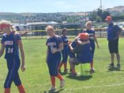 Ridgefield softball players hug coach Dusty Anchors after the team's season ended Saturday at the Class 2A state tournament in Selah.
