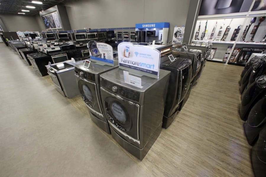 The Kenmore Elite Smart Electric Dryer and Front Load Washer, center, appear on display at a Sears store. If you are shopping for new appliances don’t fall for stores’ tricks and gimmicks.