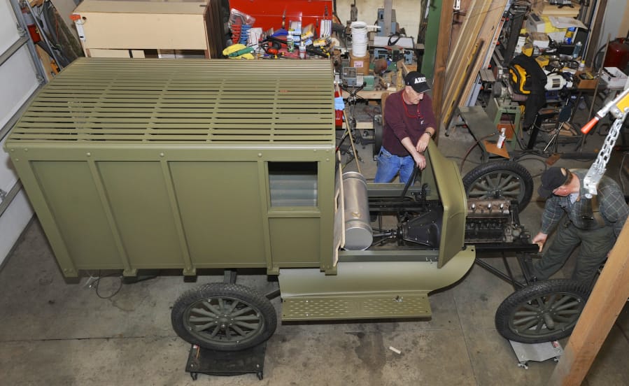 Vancouver Barracks Military Association members Lyle Wold, from left, and Tim Shotwell work on a replica of a World War I Army ambulance in 2017.