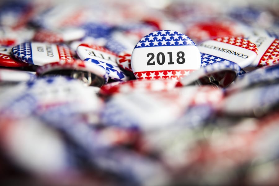 A 2018 Election Vote button on a pile of other buttons