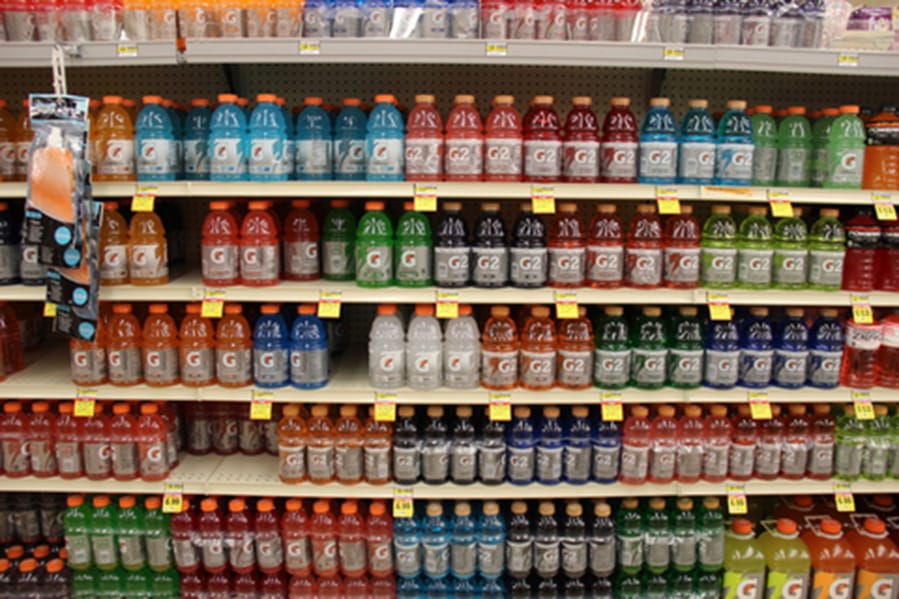 Gatorade sports drinks are displayed in a store. A 20-ounce bottle of Gatorade has 34 grams of sugar, 36 grams of carbs and 140 calories.