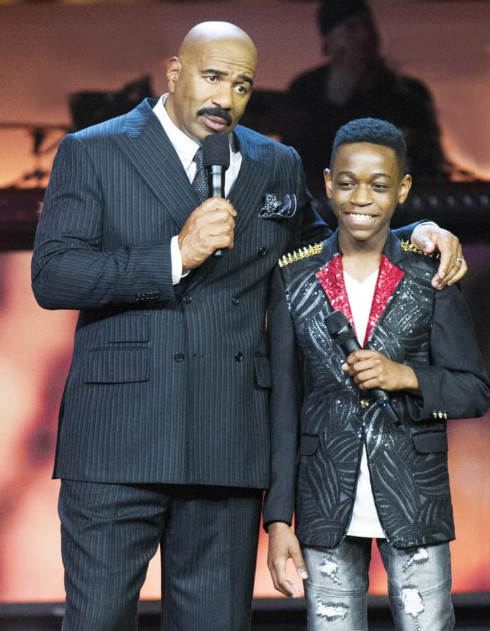 Host Steve Harvey, left, talks to contestant Decory Brown in Fox’s talent show “Showtime at the Apollo,” which will be celebrating its season finale on May 24.