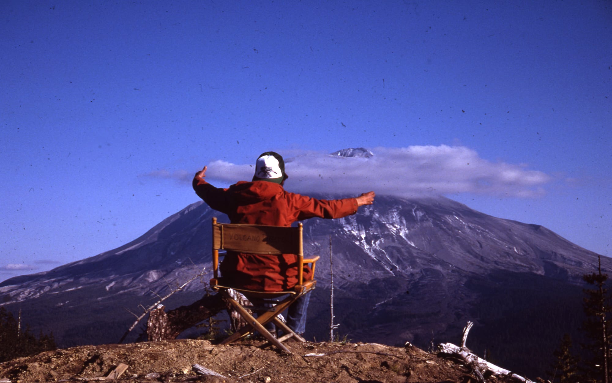 From a chair overlooking Mount St. Helens, Harry Glicken “conducts” bursts from the volcano on May 17, 1980. Glicken was scheduled to be there the following morning, but David Johnston took the shift. (Carolyn Driedger/U.S.