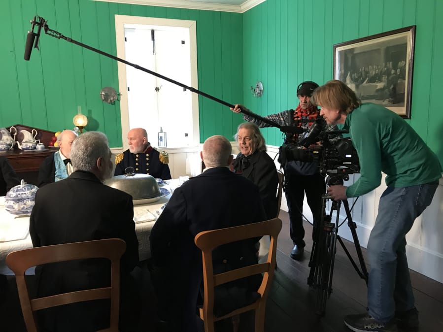 Dr. John McLoughlin (portrayed by Ron Cronin) presides over the meal at the head of the table as sound man William Ward and cameraman Greg Bond film the scene in the Chief Factor’s House in December at Fort Vancouver.