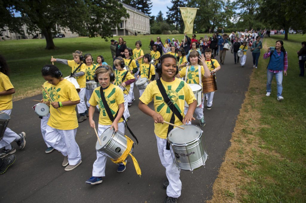 The Hough Elementary School after school program Youth Escola de Samba drum and march together during the Children's Cultural Parade at Fort Vancouver National Historic Site on Friday, May 11, 2018. The National Park Service, the Evergreen School District, and the Vancouver School District came together for the annual event to support local students and celebrate the region's historical diversity.