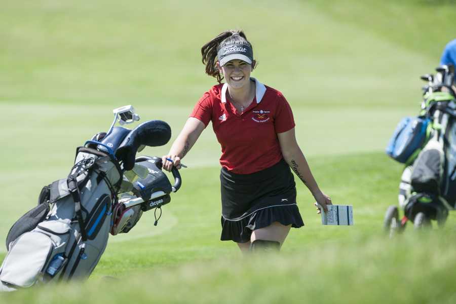 Prairie senior Delainey Patterson smiles as she moves to the next hole during the 4A and 3A district girls golf tournament at Tri-Mountain Golf Course in Ridgefield, Tuesday May 8, 2018.