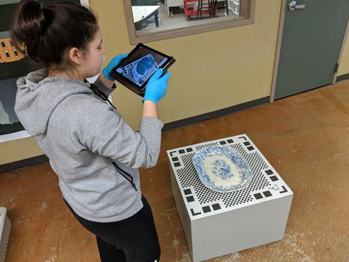 Kiera Navarro, a student at Vancouver iTech Preparatory Middle School, scans a platter from the Fort Vancouver National Historic Site collections in her Washington state history class. Students have taken 3D scans of artifacts to build an online museum.