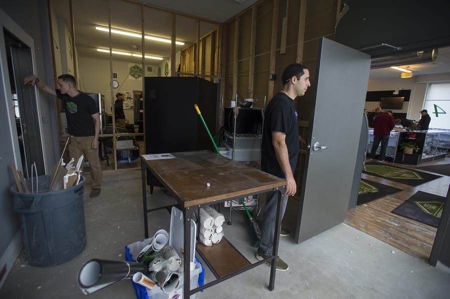 Main Street Marijuana co-owners Jason Keller, left, and Adam Hamide stand in an employee area soon to be remodeled. The store took over the 2,000-square-foot shop next door and plans to expand its showroom.