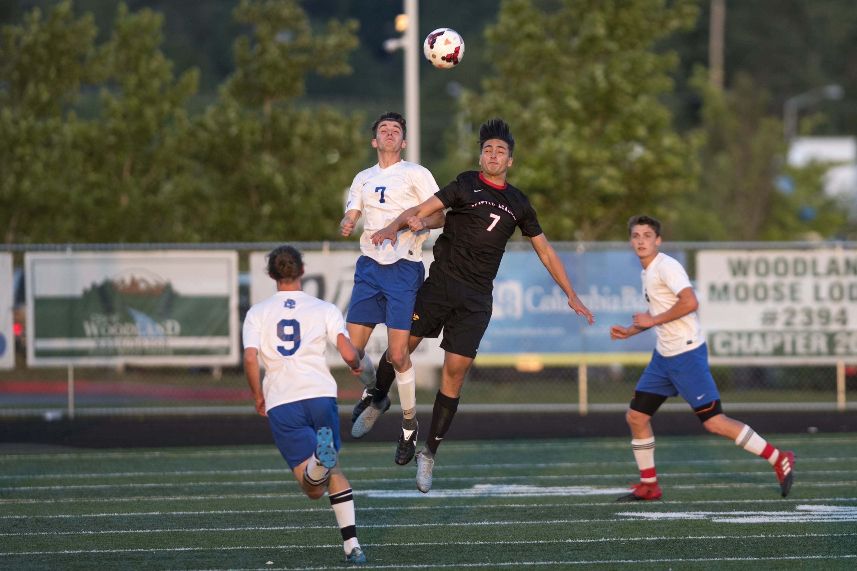 La Center's Jared Cox, 7, and Seattle Academy's Cole Hanauer, 7, jump for a header during the first round of the Class 1A state playoffs at Woodland High School on Tuesday, May 15, 2018.