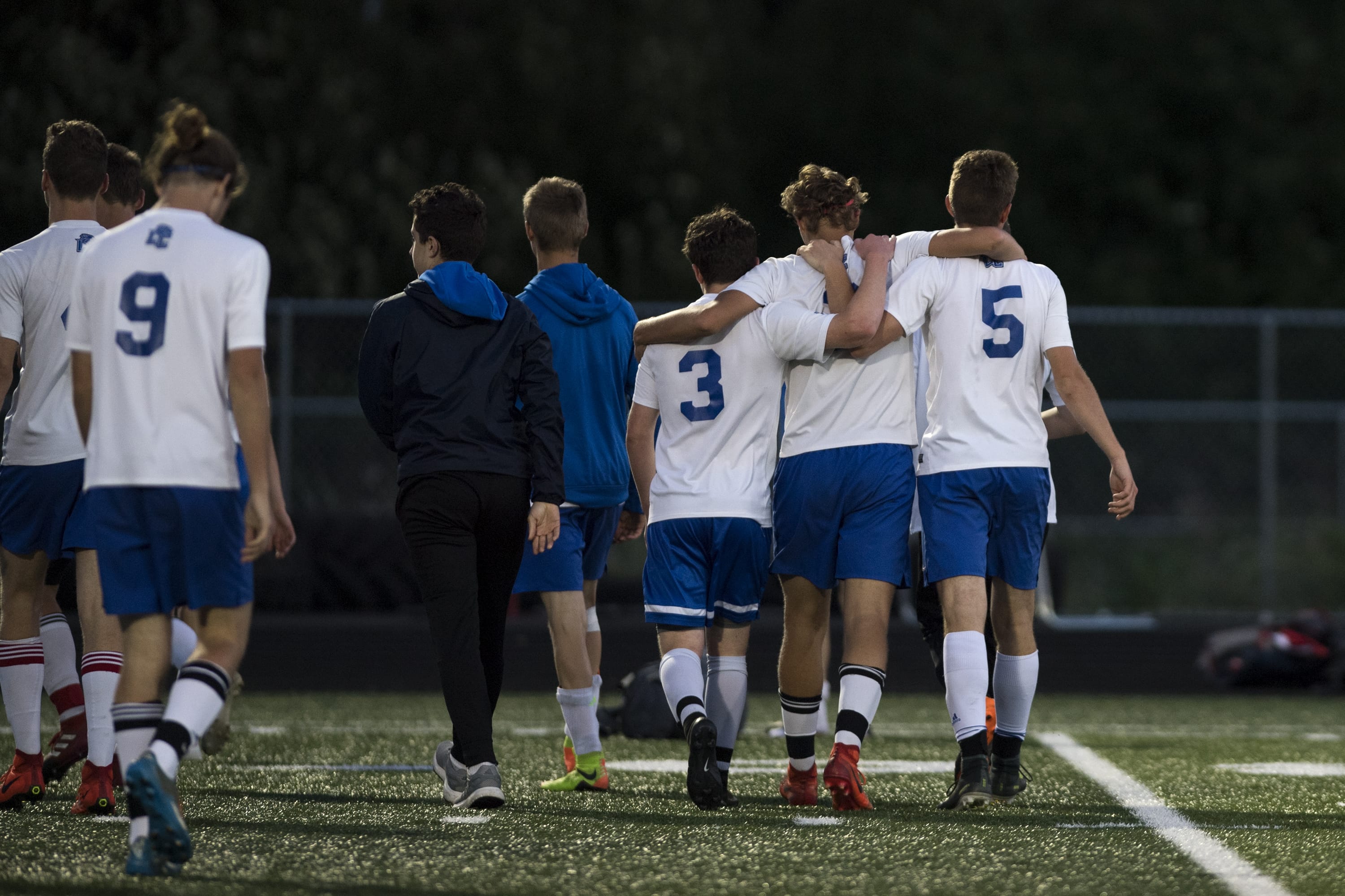 La Center players comfort each other after a defeat by Seattle Academy during the first round of the Class 1A state playoffs at Woodland High School on Tuesday, May 15, 2018.