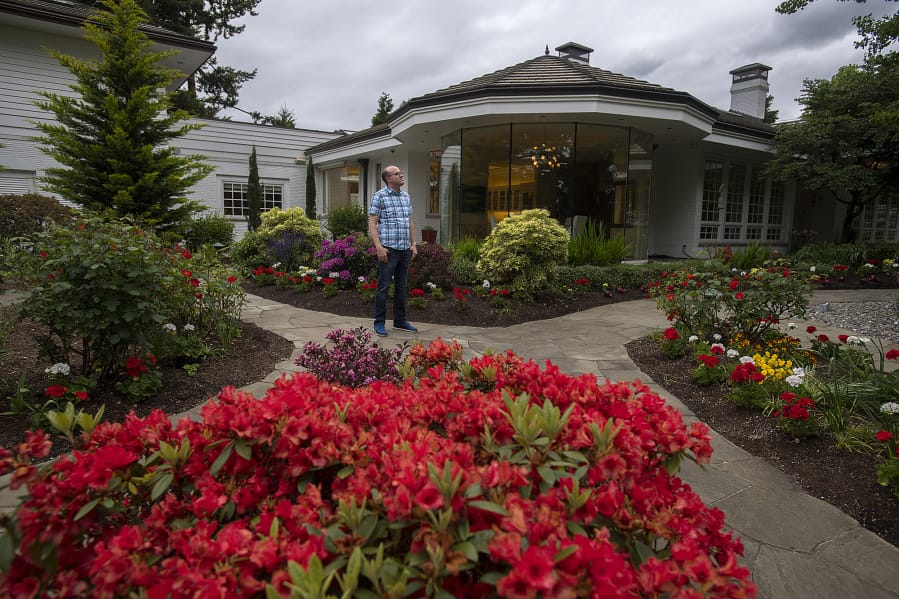 Jim Mains of the Ed and Dollie Lynch estate pauses for a photo outside the late philanthropists’ former home. At 4712 N.W. Franklin St., Vancouver, the 12,000-square-foot home is one of 20 high-end homes open to the public on Sunday.